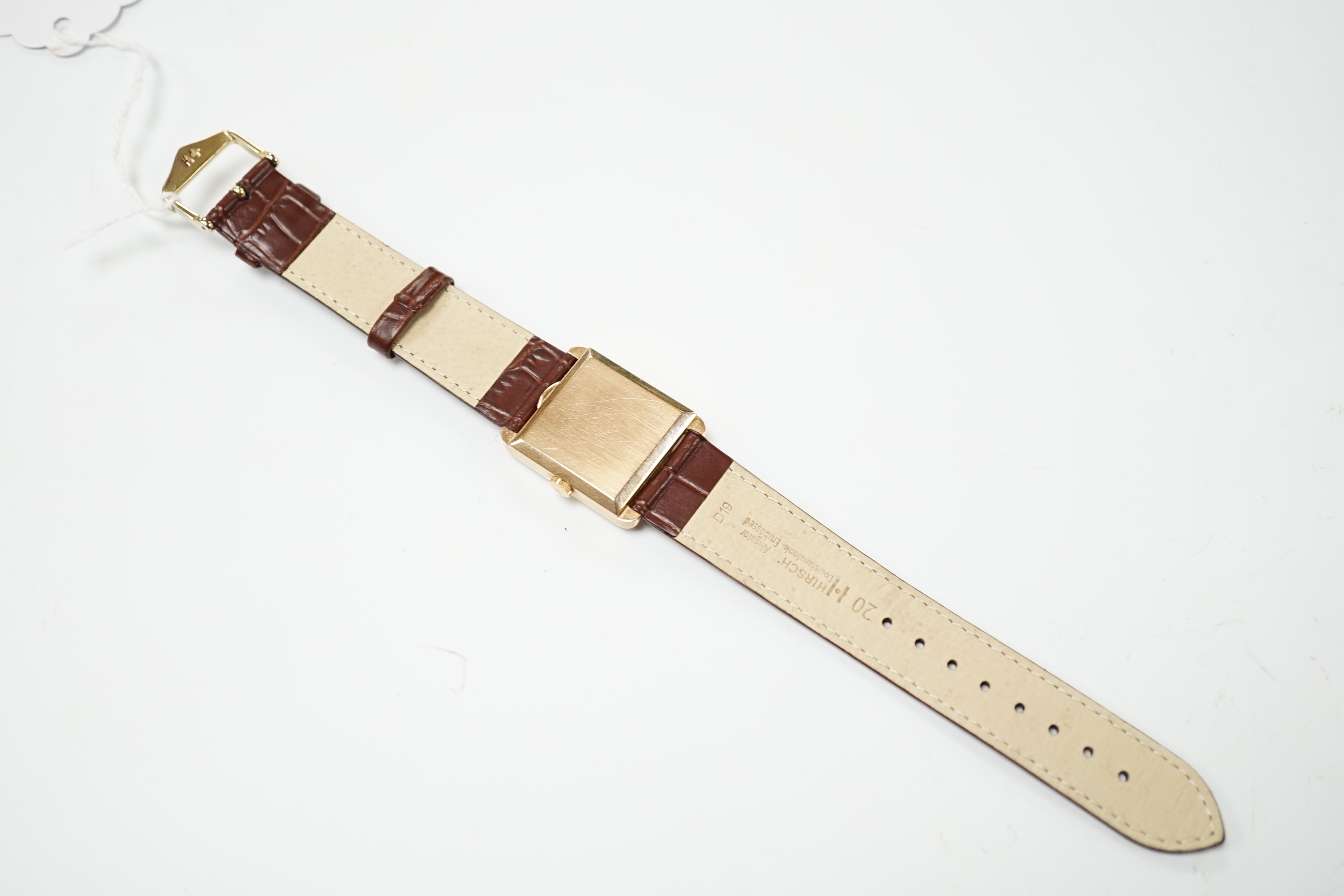 A gentleman's 18ct gold Jaeger LeCoultre manual wind dress wrist watch, with square dial, milled bezel and baton and quarterly Arabic numerals, on associated leather strap, case diameter 26mm, gross weight 31.8 grams.